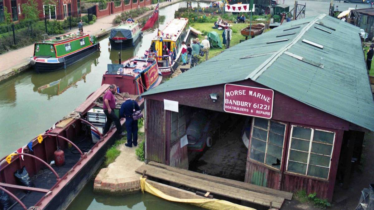 A traditional narrowboat moored at the historic brick workshops of Tooley's Boatyard along the Oxford Canal in Banbury.