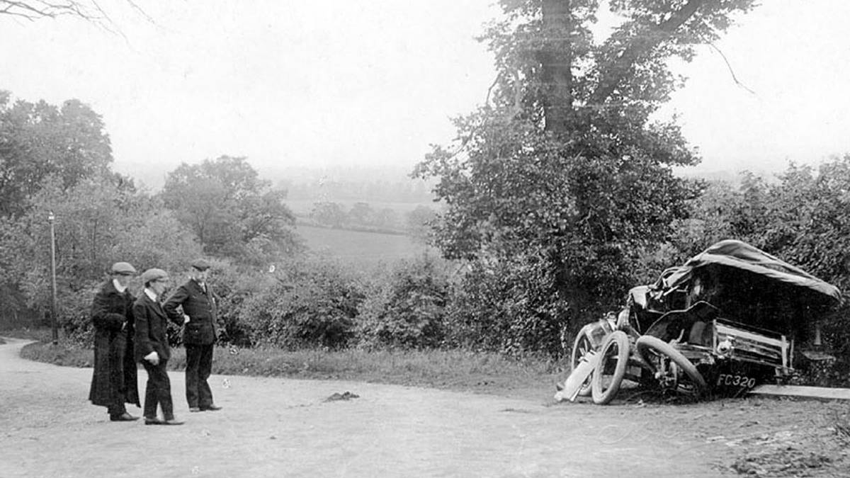 Scene of a motor car accident on Sunrising Hill, Edgehill. June 10th 1907. Three men looking at wrecked car.