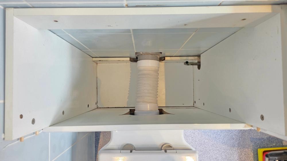 Empty boxed-in unit behind the toilet with the old cistern taken out