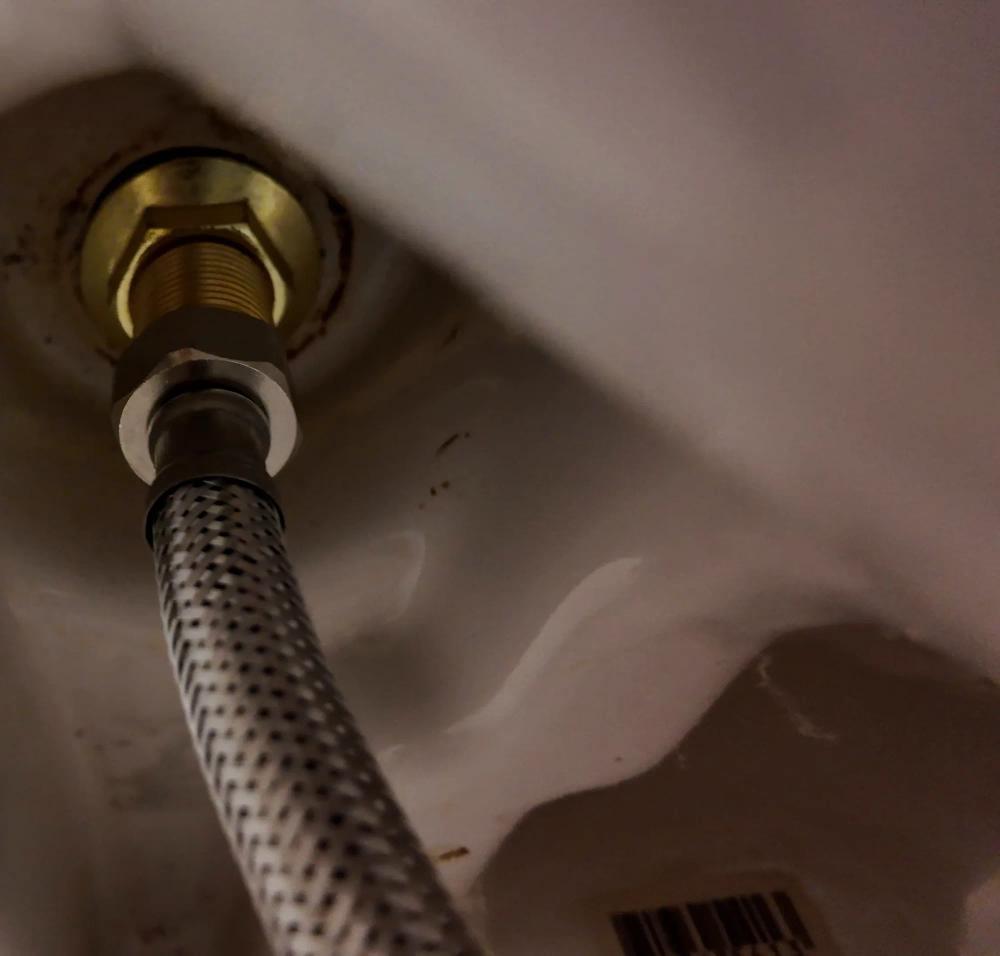 New flexible tap connector fitted to the tap under the basin.