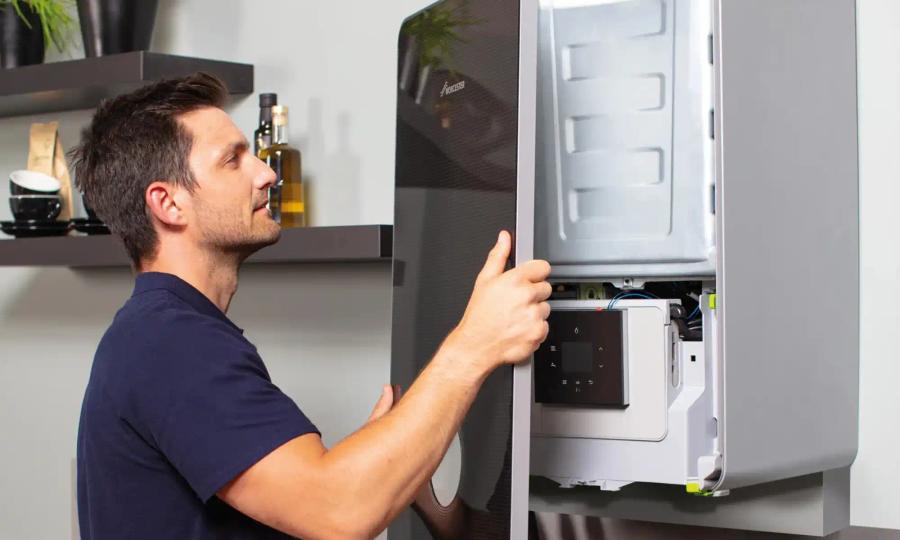 Engineer working inside an open boiler