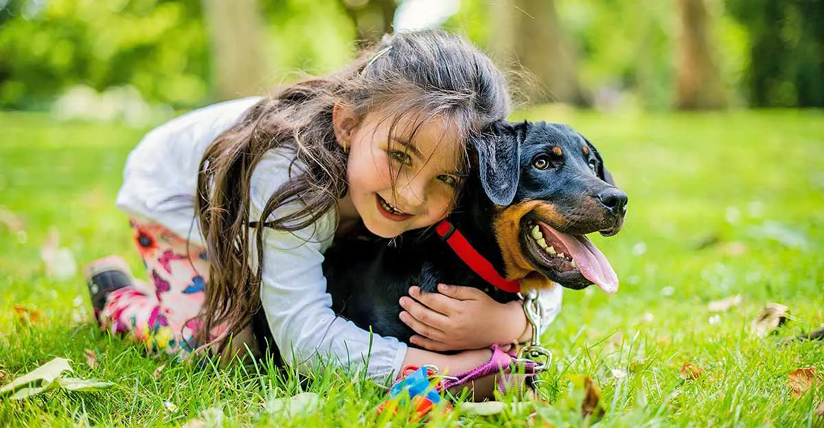 happy smiling girl hugging dog park