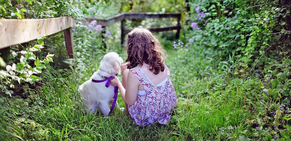 little girl with dog backyard