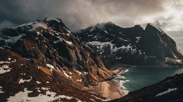 Mountains in cloudly weather with a beach.