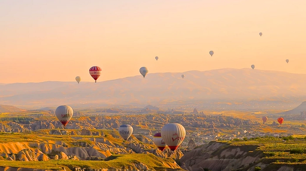 Hot air Balloons floating over mountains
