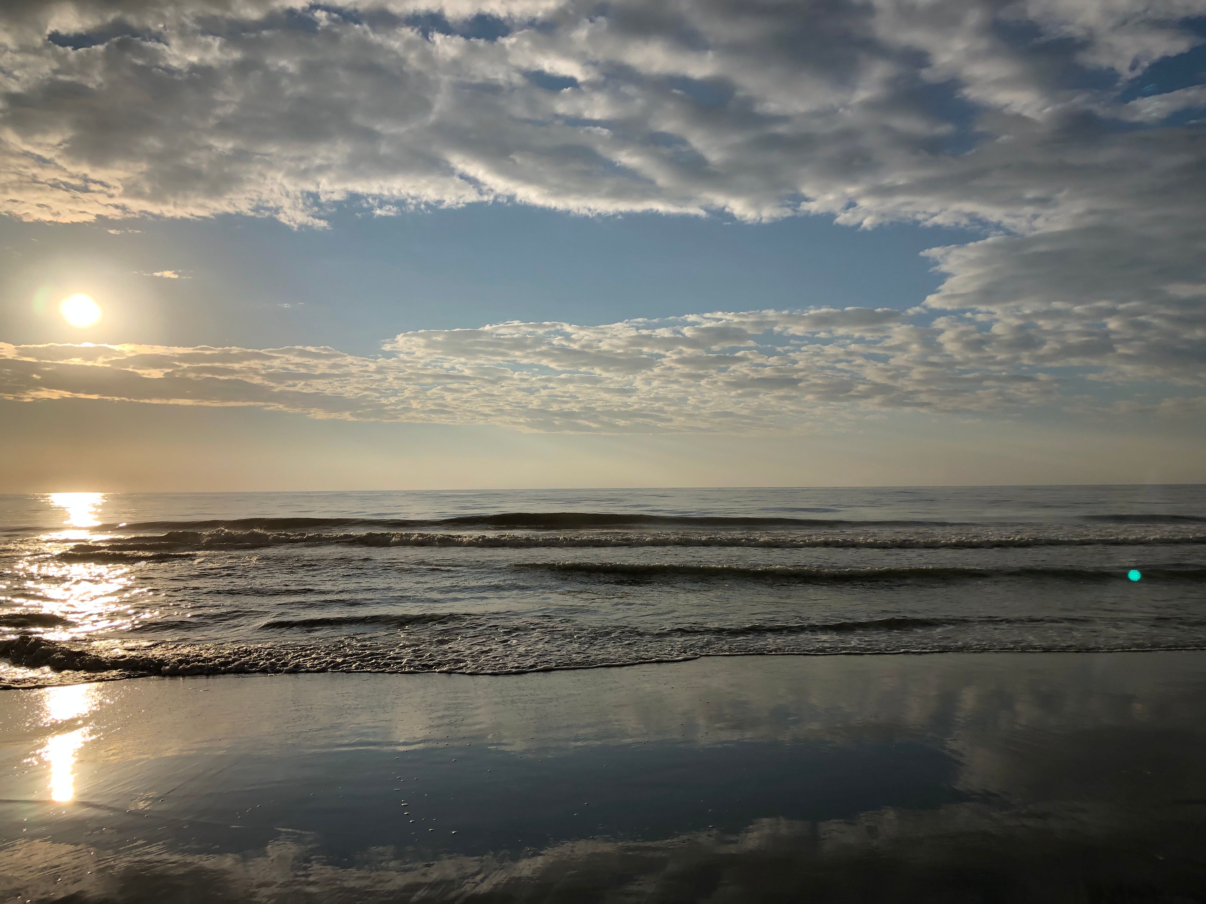 Ocean with sun above and small waves