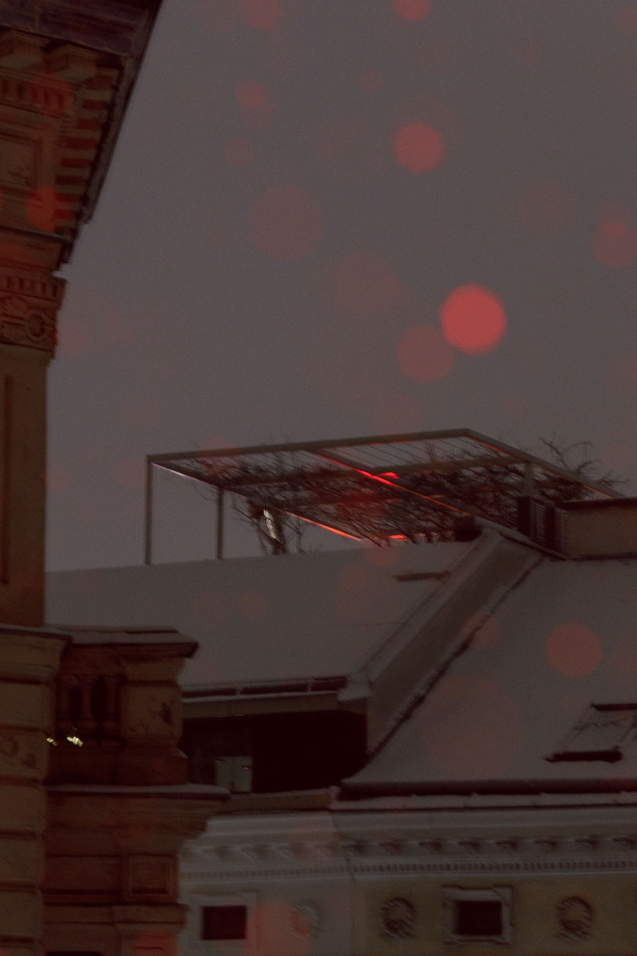 red winter night snowy rooftop balcony