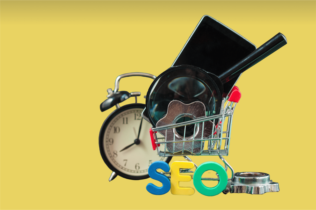 Miniaturowy koszyk zakupowy z tabletem, zegarem i literami SEO na żółtym tle