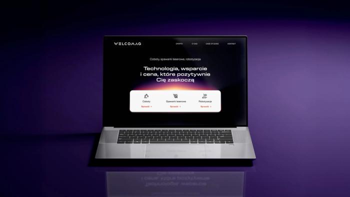 Laptop prezentujący stronę internetową Welcomag z nowoczesnym ciemnym brandingiem