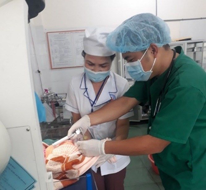 doctor and nurse treating newborn