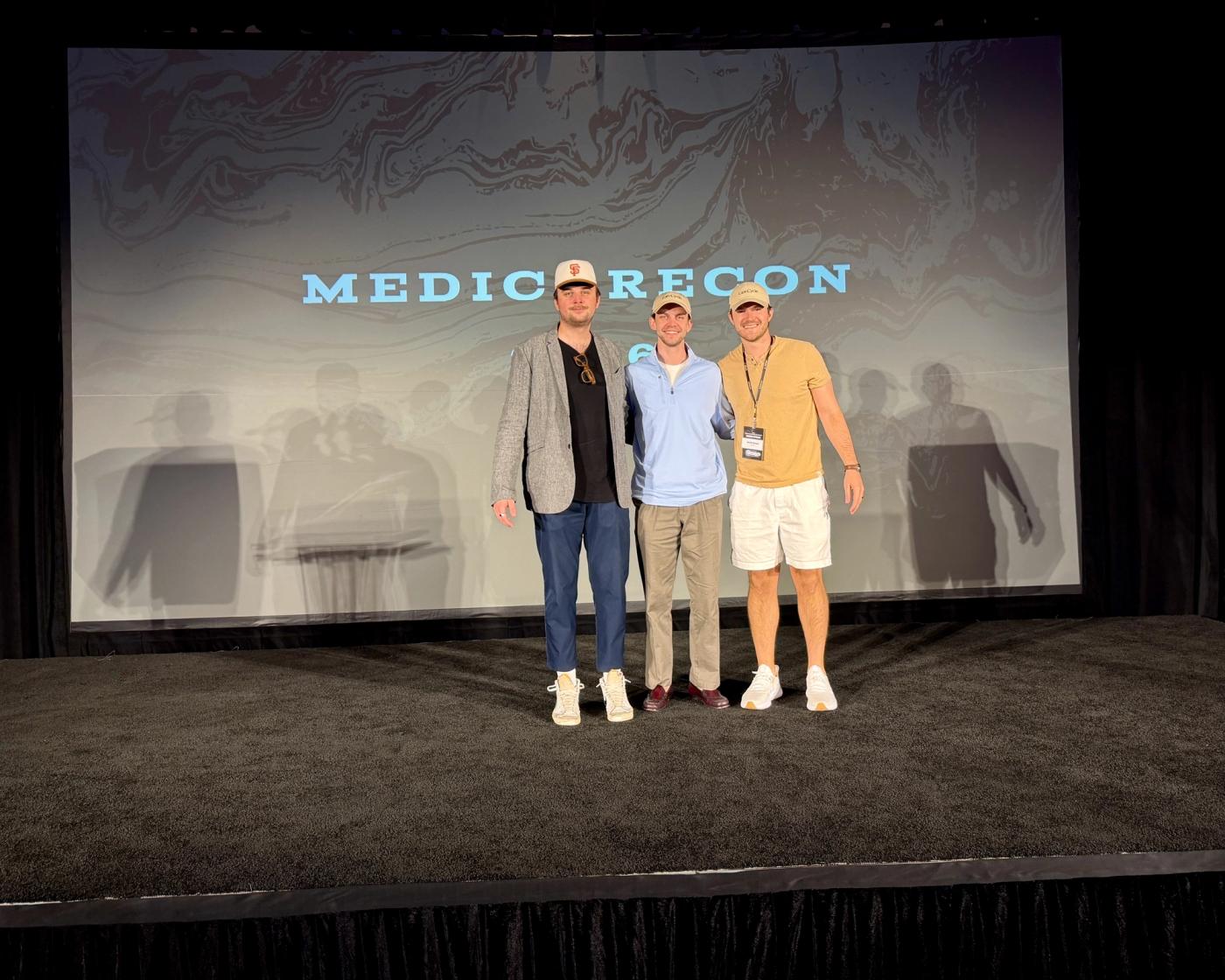 MedicareCon team photo (Vladimir, Zach, Jacob) standing on stage.