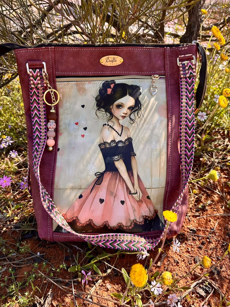 Purple bag with girl in black and pink lace dress