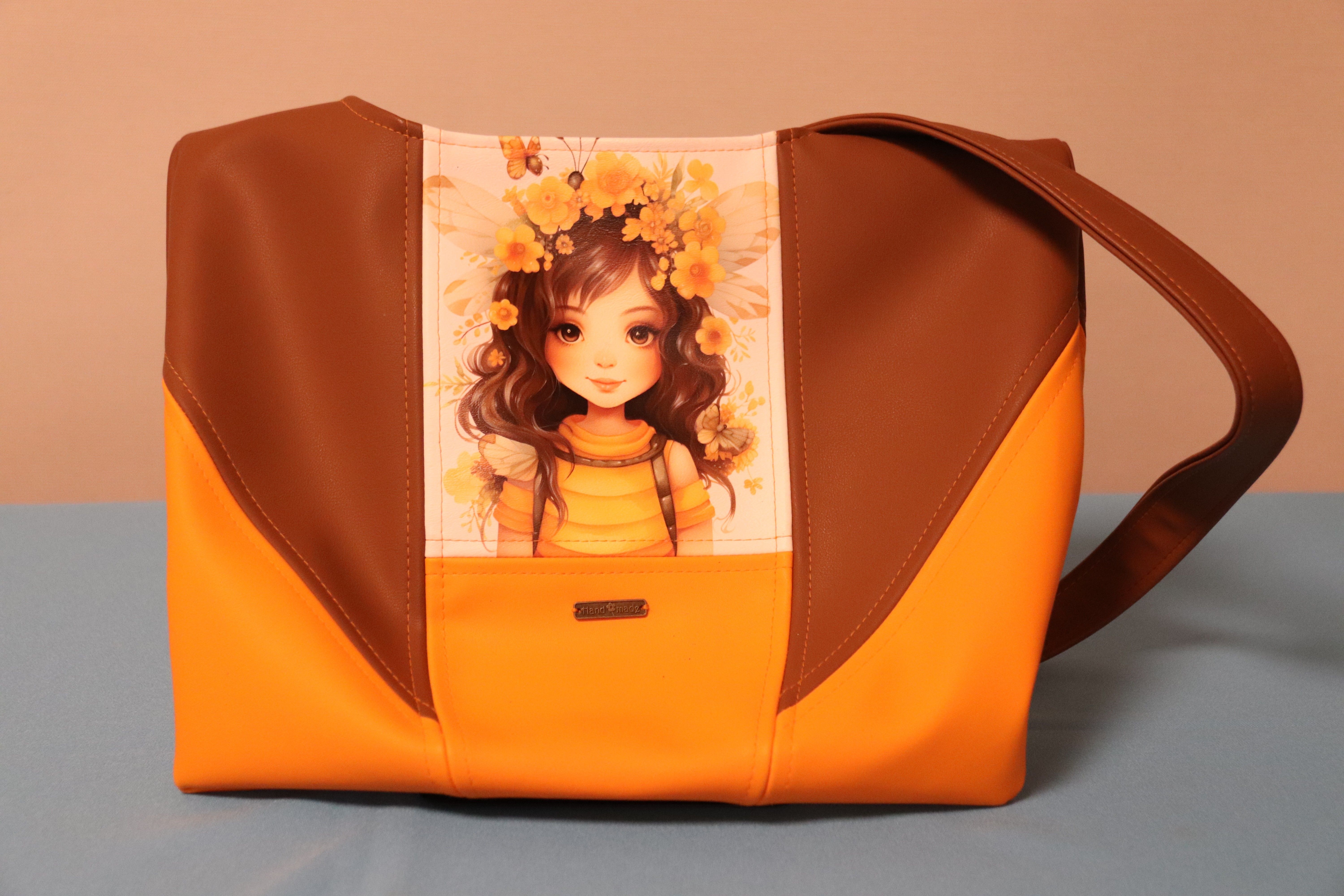 Large orange and brown shoulder bag with flower girl print