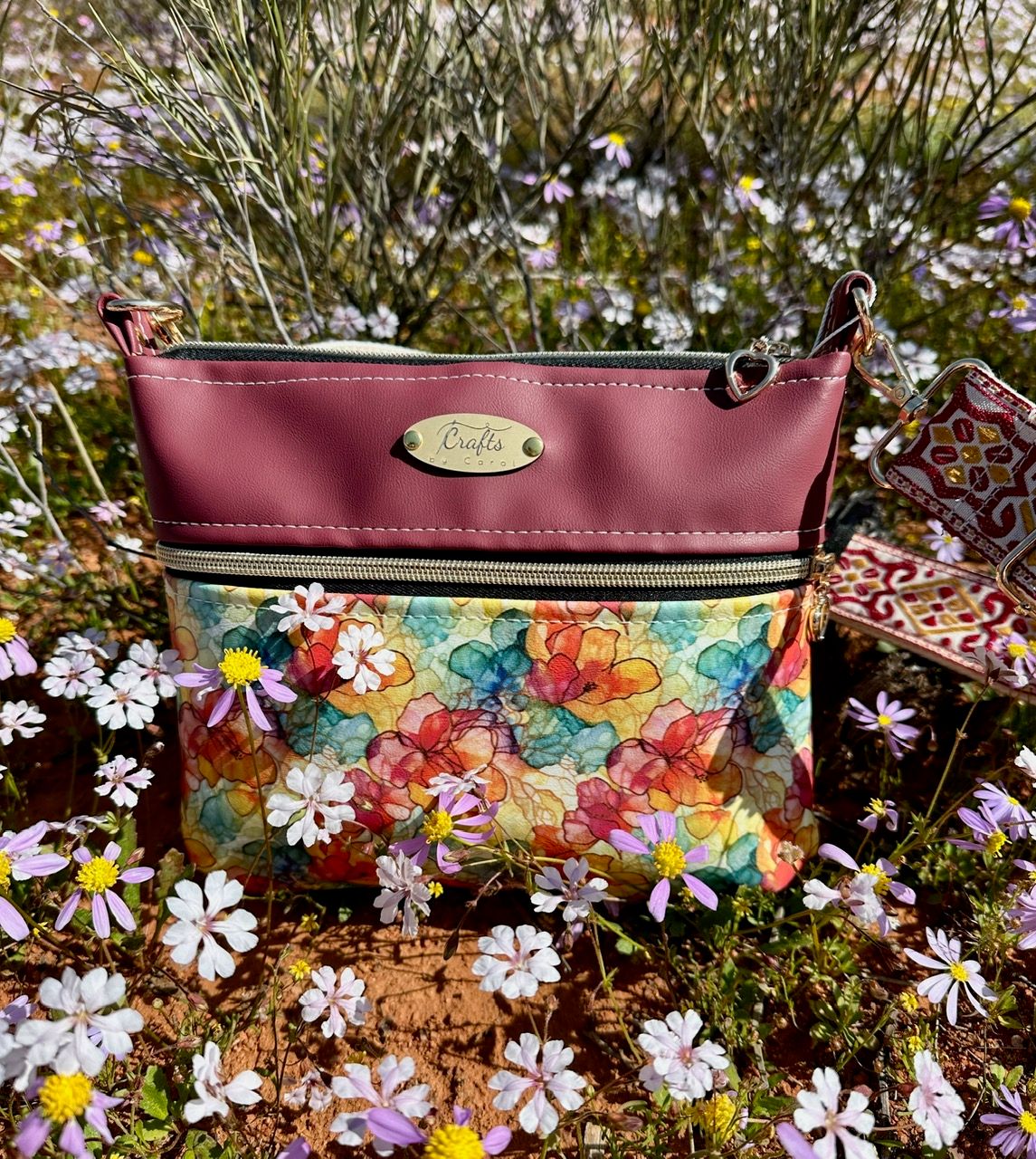 Burgundy bag with floral print.