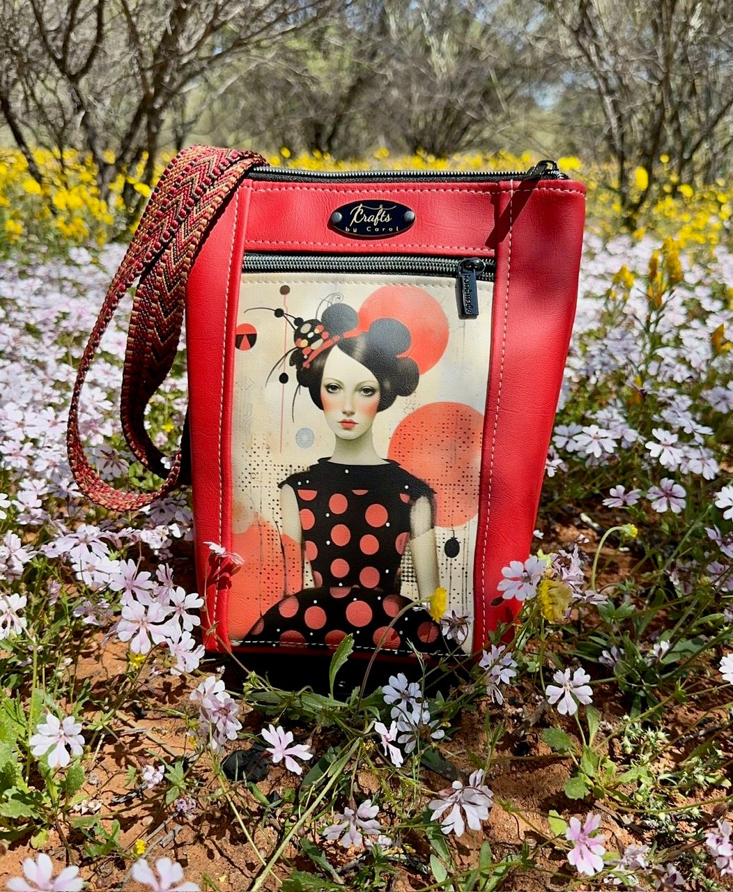 red bag with girl in black dress with red spots