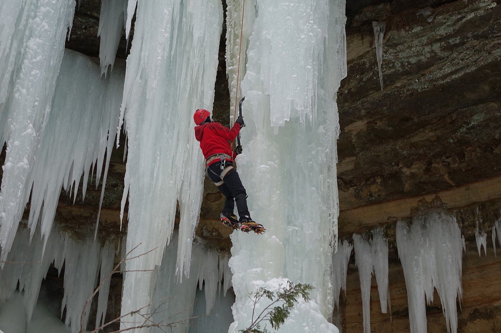 Ice climbing with crampons and ice axe