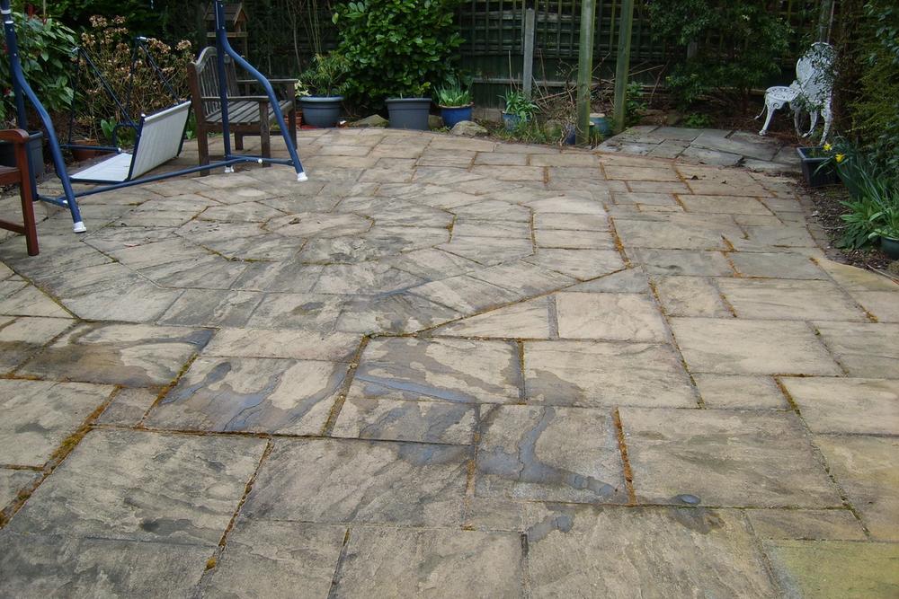 Large flagged patio, before