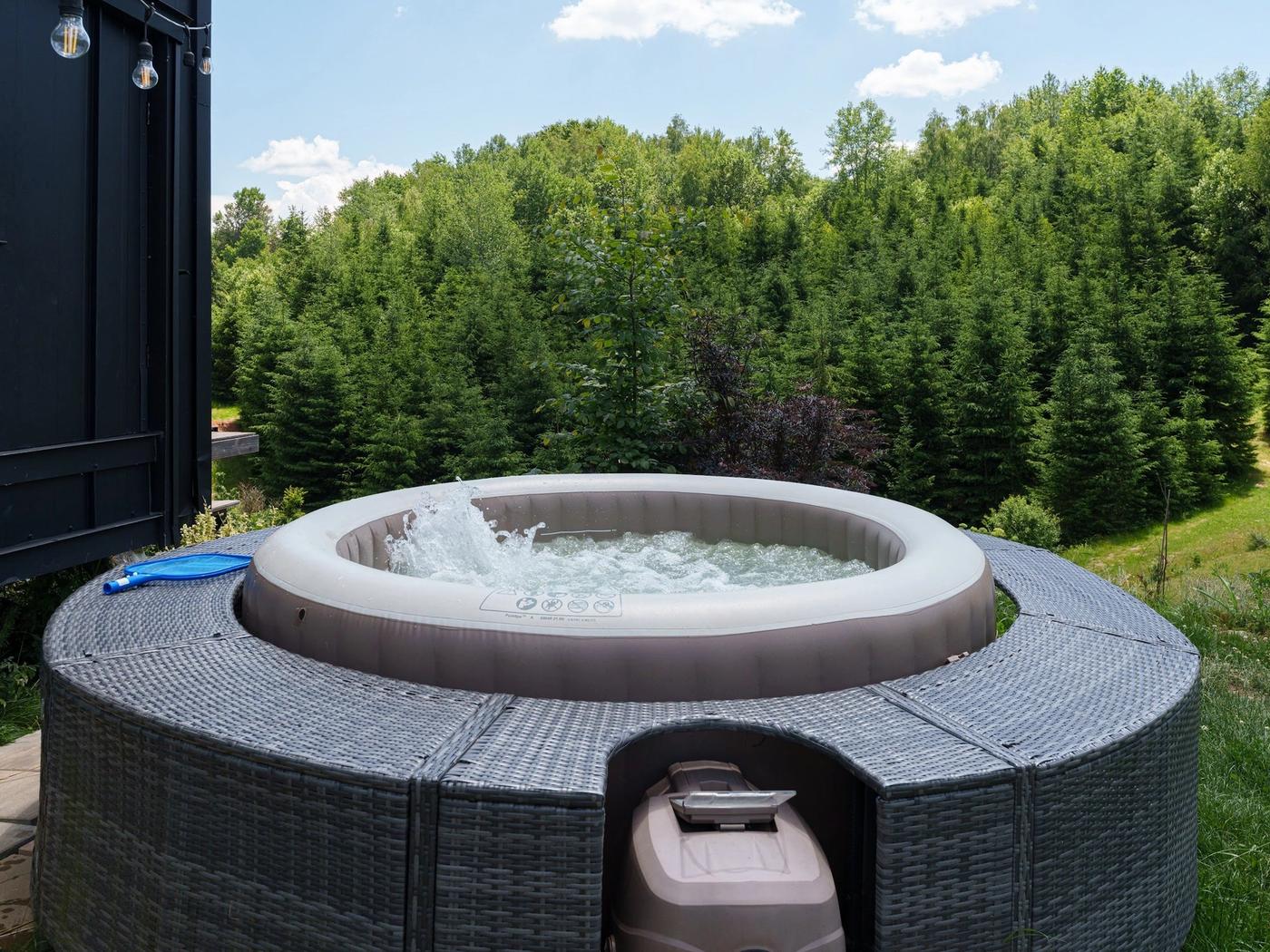 Hot tub with forest view Private hot tub on the deck of the Dyno tiny house, overlooking the pine forest