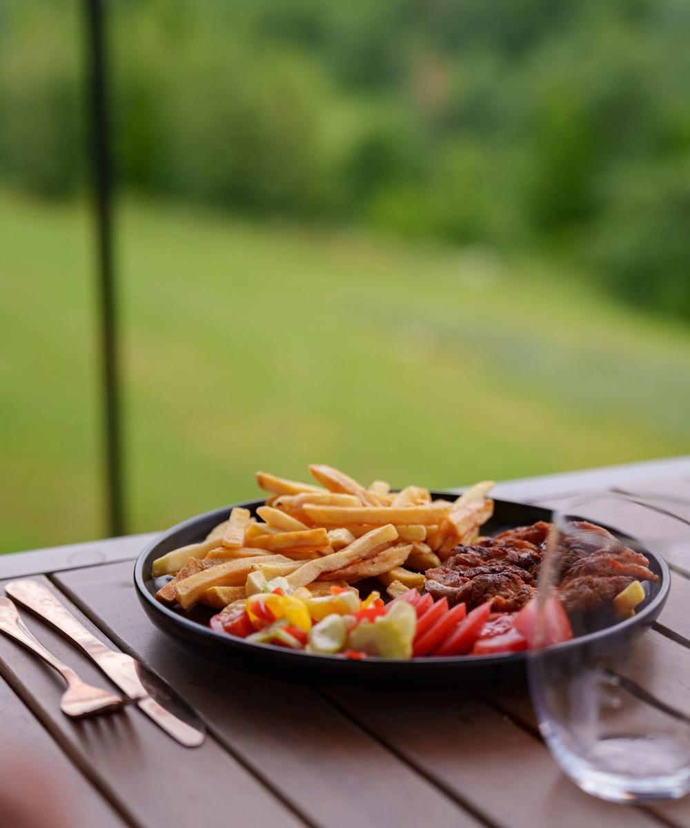 Steak with fries and vegetables Steak with fries and fresh vegetables, served on the terrace
