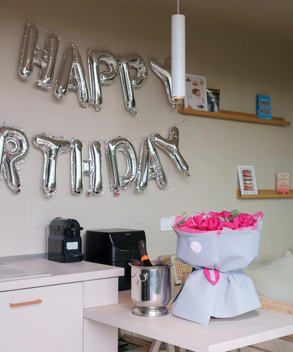 Birthday Celebration Setup at Coniferis Birthday setup with Happy Birthday balloons, rose bouquet and prosecco in a Coniferis tiny house