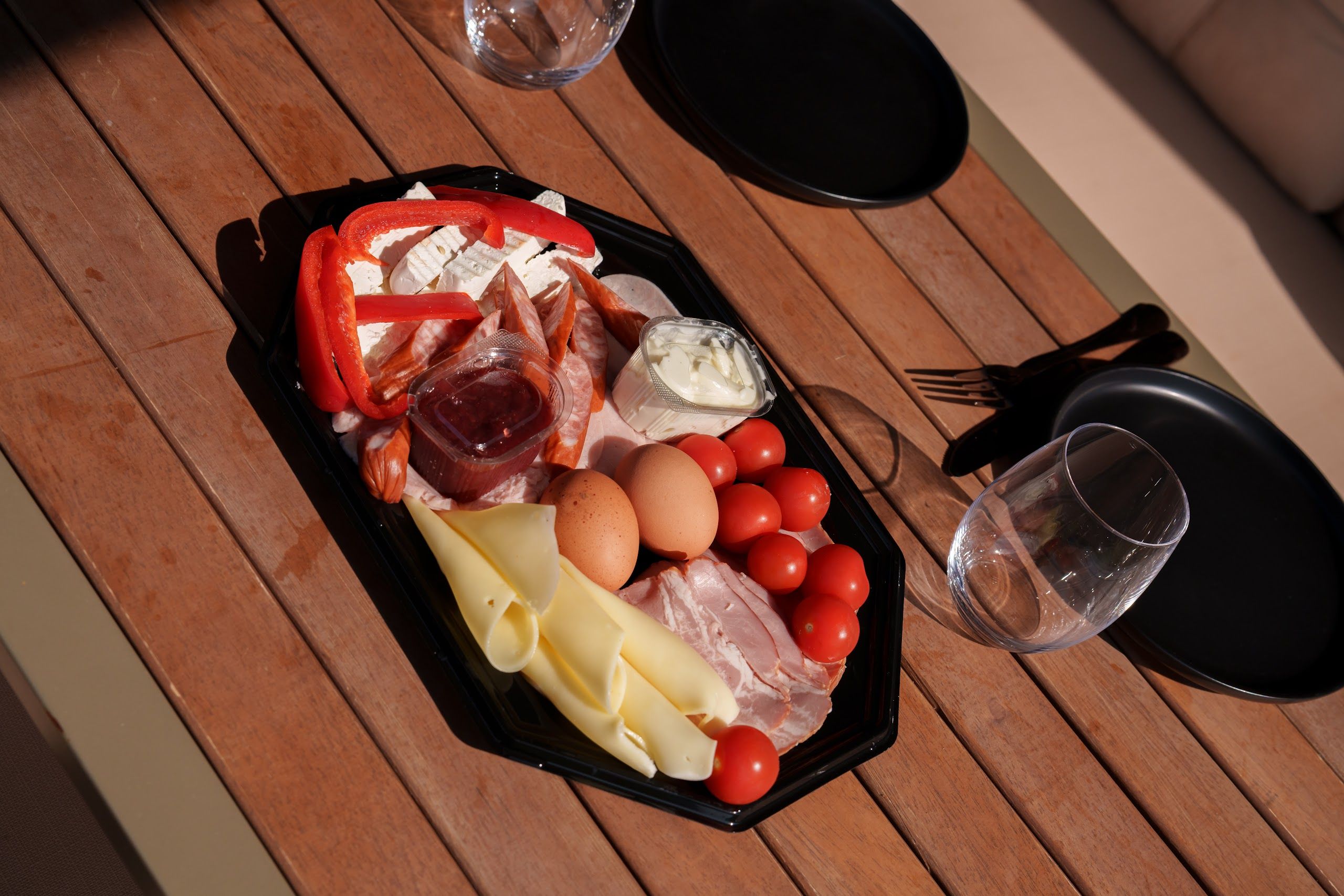 Platter of cheeses, cured meats, eggs and fresh vegetables from the village pantry