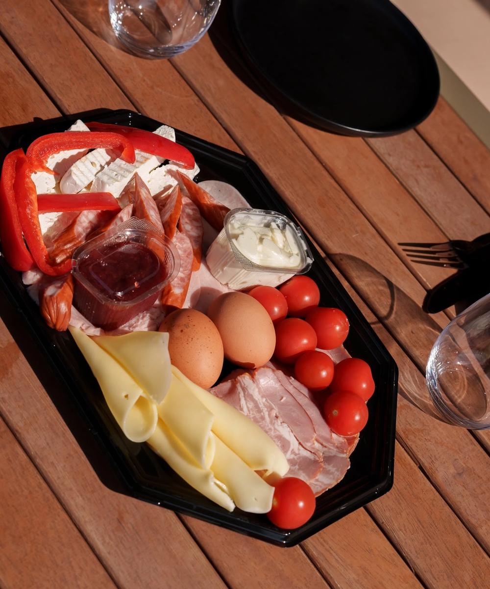 Platter of traditional products Platter of cheeses, cured meats, eggs and fresh vegetables from the village pantry