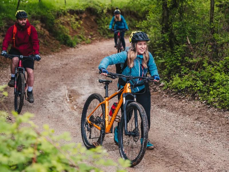 40 kilometres, with a sustained climb at the start A cyclist cornering on a forest road in the Pădurea Craiului Mountains