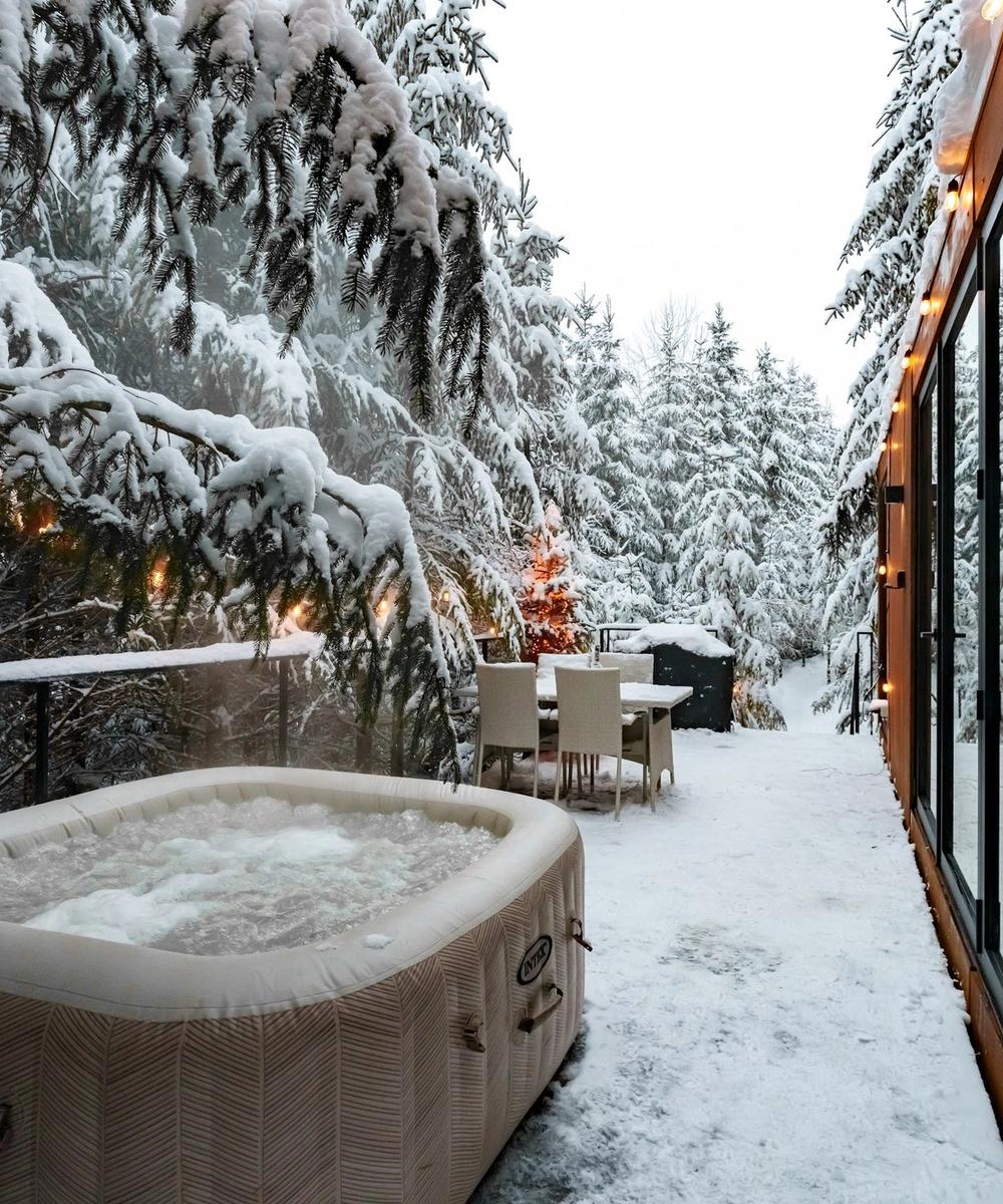 Outdoor hot tub in winter Outdoor hot tub in winter among the snow-covered firs at Luna Tiny House