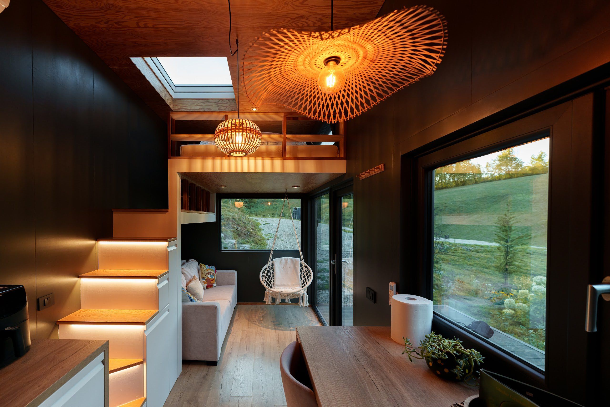 Eco-luxury interior with panoramic forest window at Cappuccino