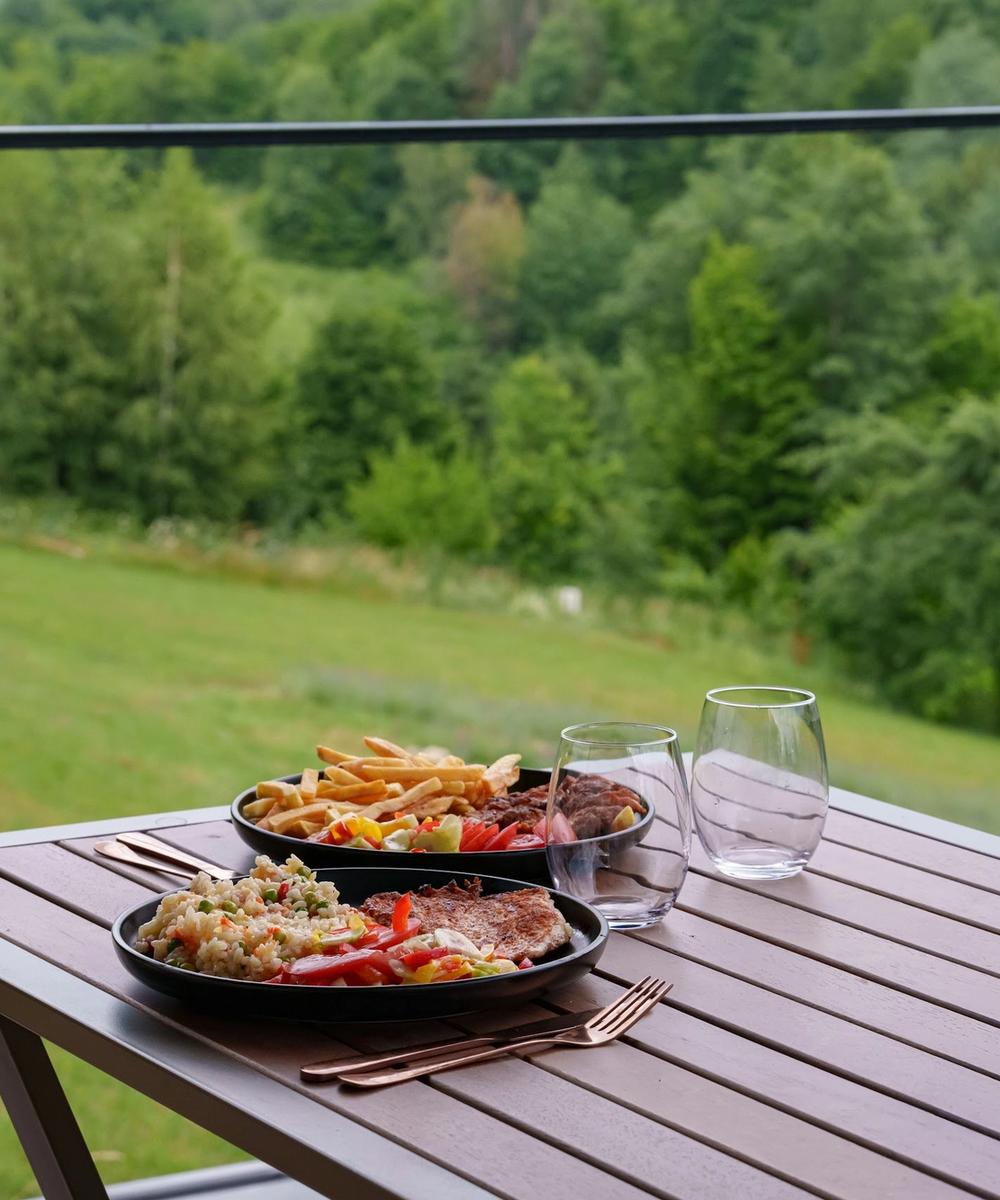 Terrace dining with a view Meal served on the terrace with a view of the Apuseni forests