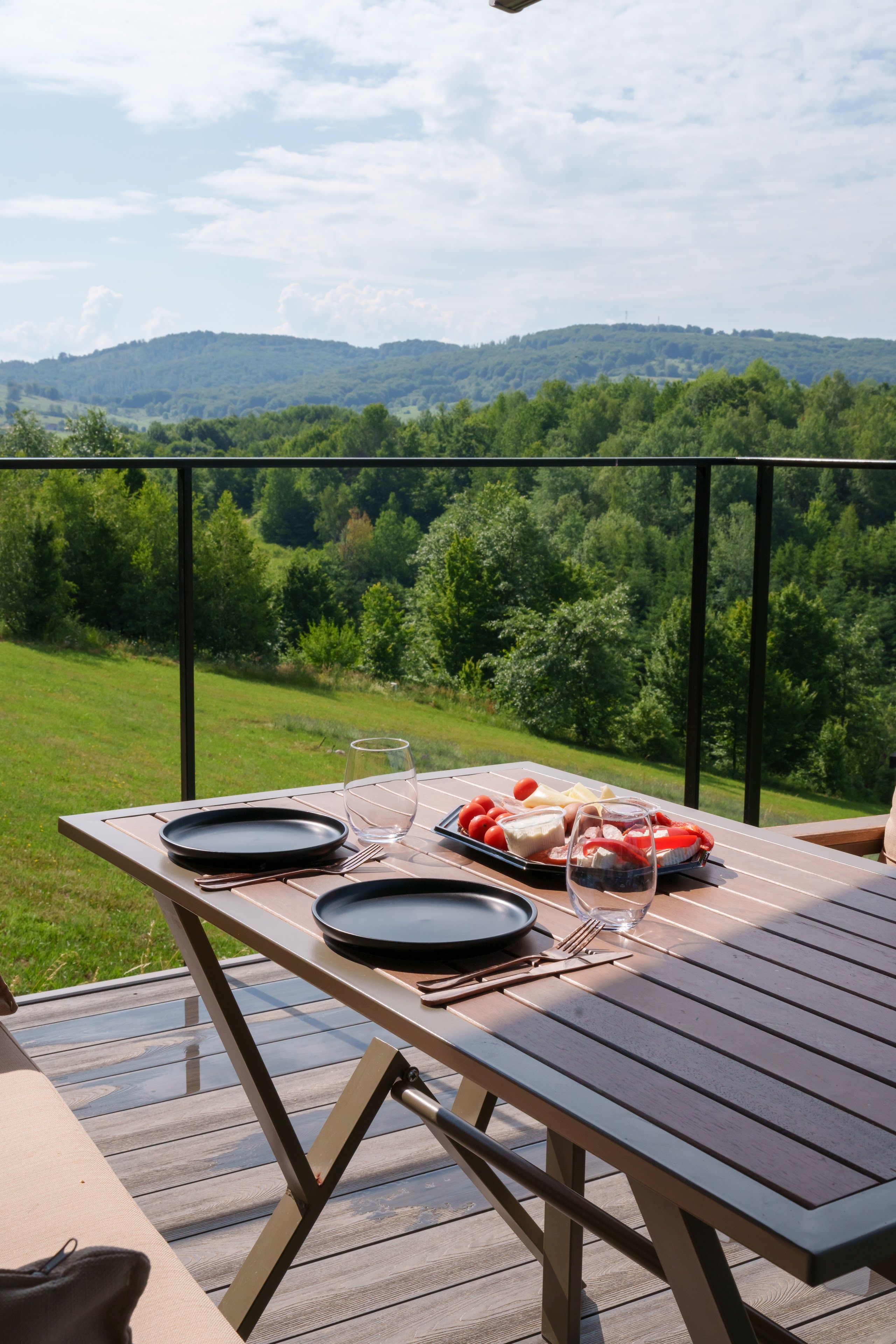 Breakfast with traditional products on the panoramic terrace, with the hills in the background