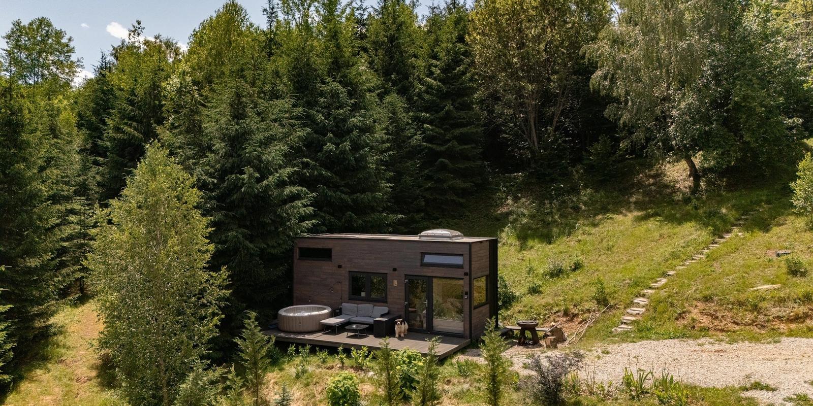 Aerial view of the Cappuccino tiny house among the fir trees at Coniferis Retreat