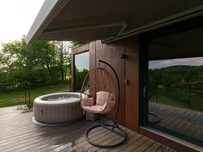 Hot tub and hanging chair Outdoor hot tub and hanging chair on the deck of the Tiramisu tiny house