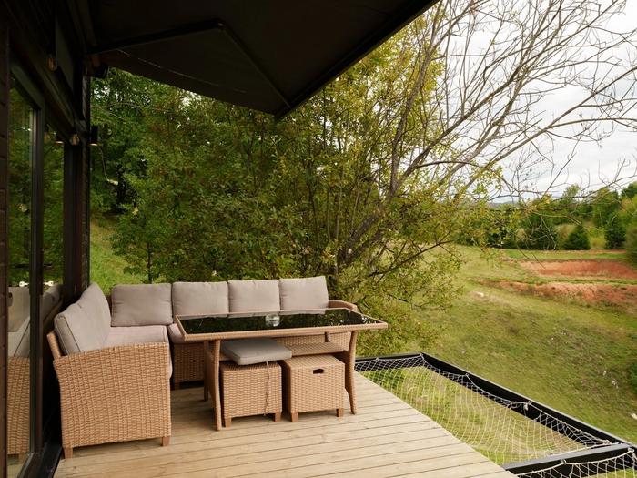 Deck with valley view Furnished deck overlooking the valley at the Dyno tiny house