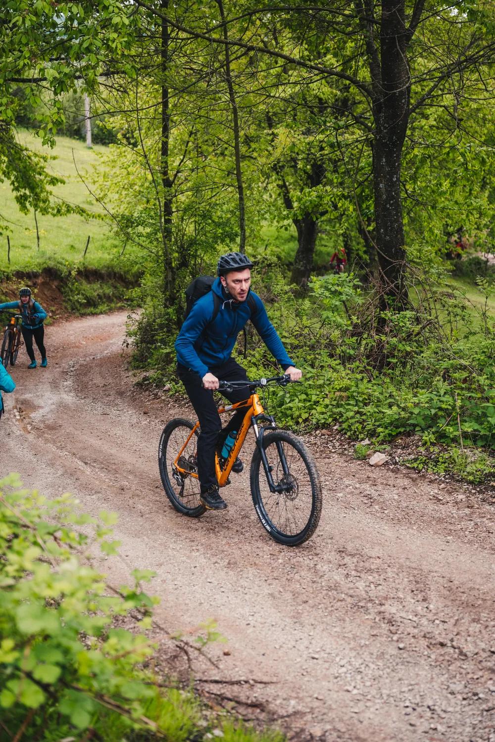 A lone cyclist on a mountain bike trail in the Pădurea Craiului Mountains