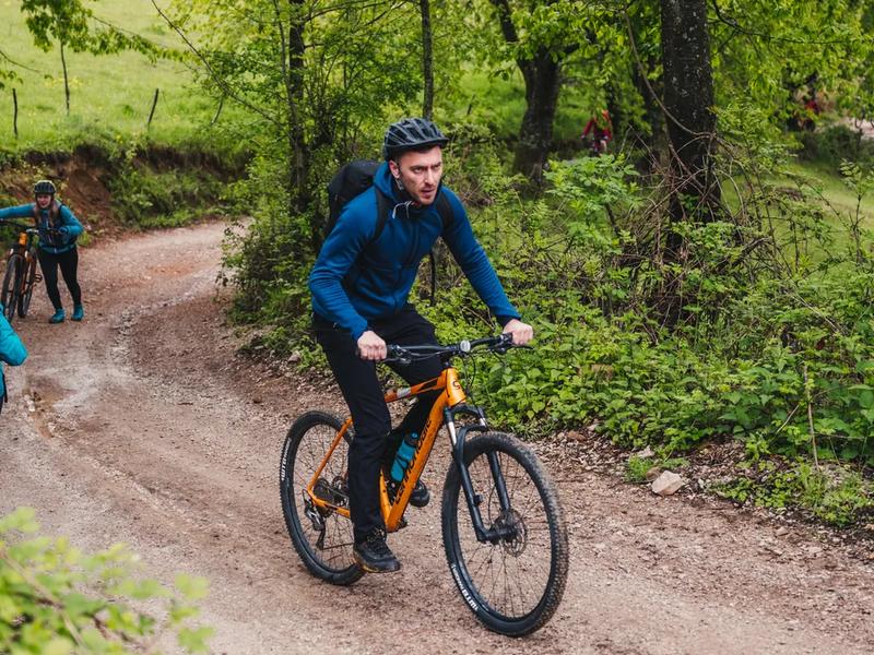 The trails can be ridden solo, if your navigation is good A lone cyclist on a mountain bike trail in the Pădurea Craiului Mountains