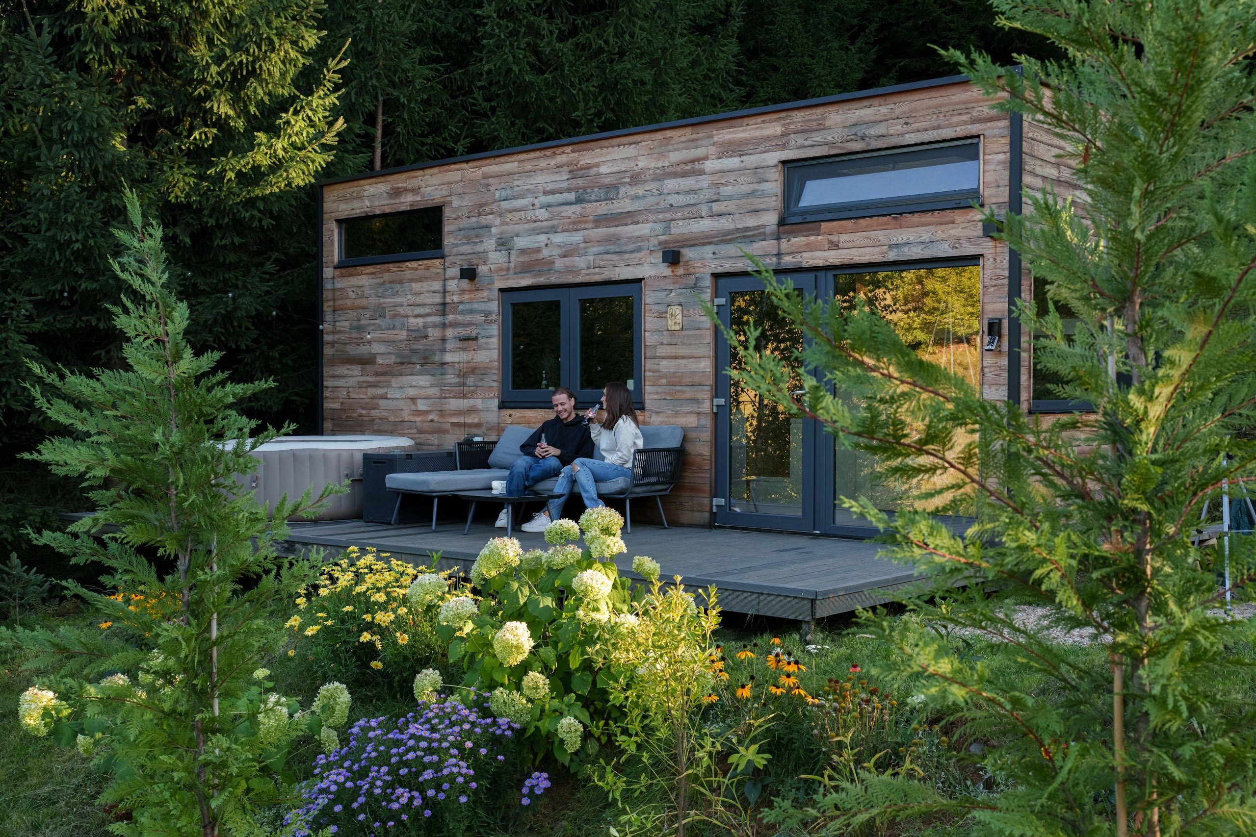 Exterior of Cappuccino cabin in summer, among the fir trees of Bihor