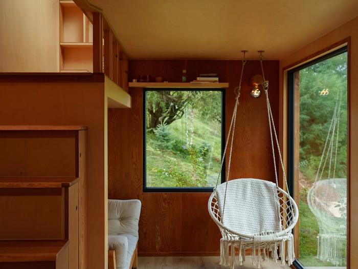 Hanging chair – Hypo Hanging chair with forest view inside the Hypo cabin