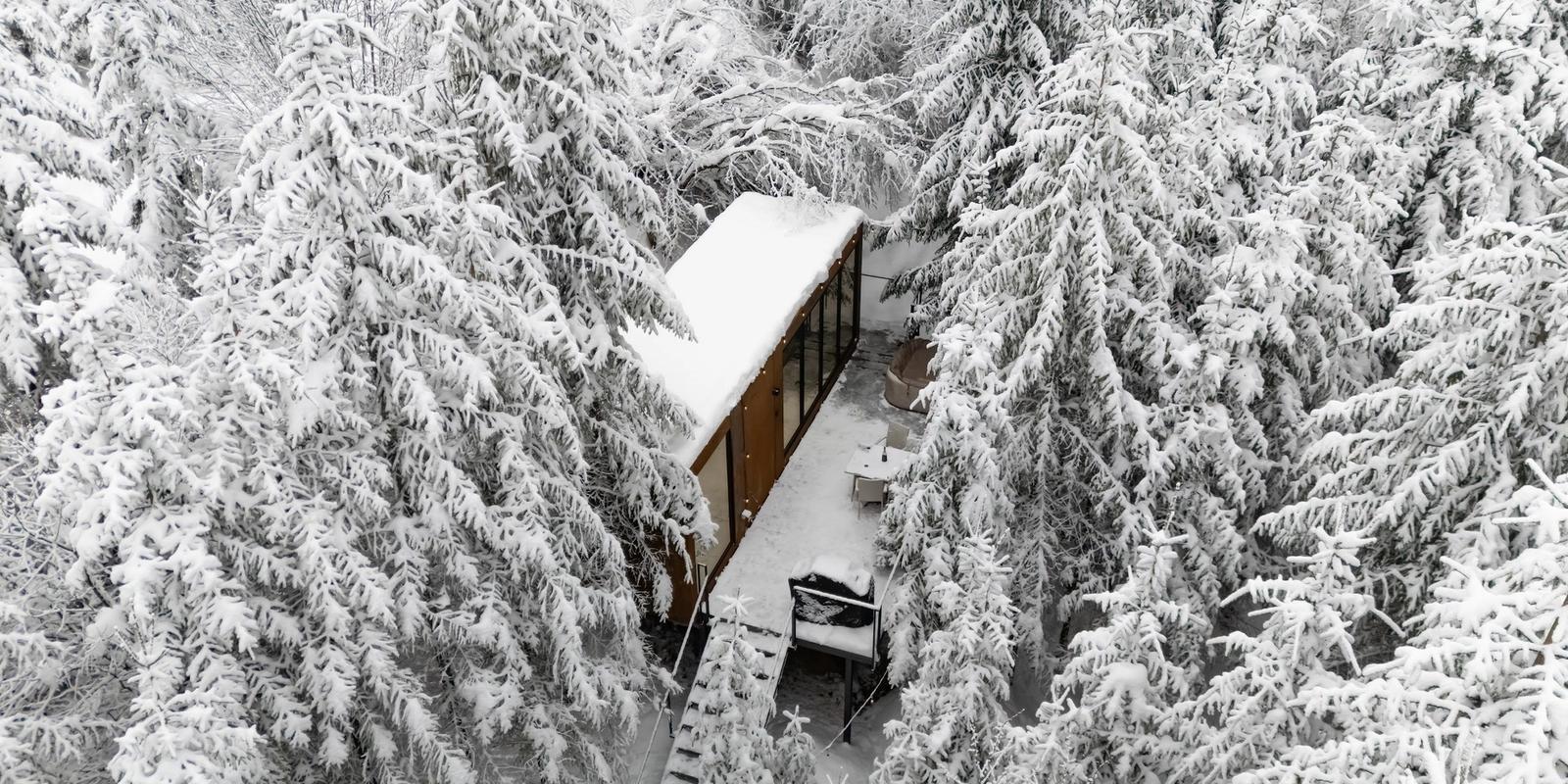 Tiramisu tiny house at sunset among the trees of the Apuseni Mountains