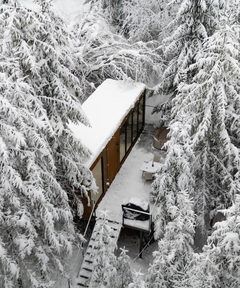 The Luna tiny house in winter, from above Aerial view of the Luna tiny house in the snow-covered forest of the Apuseni Mountains