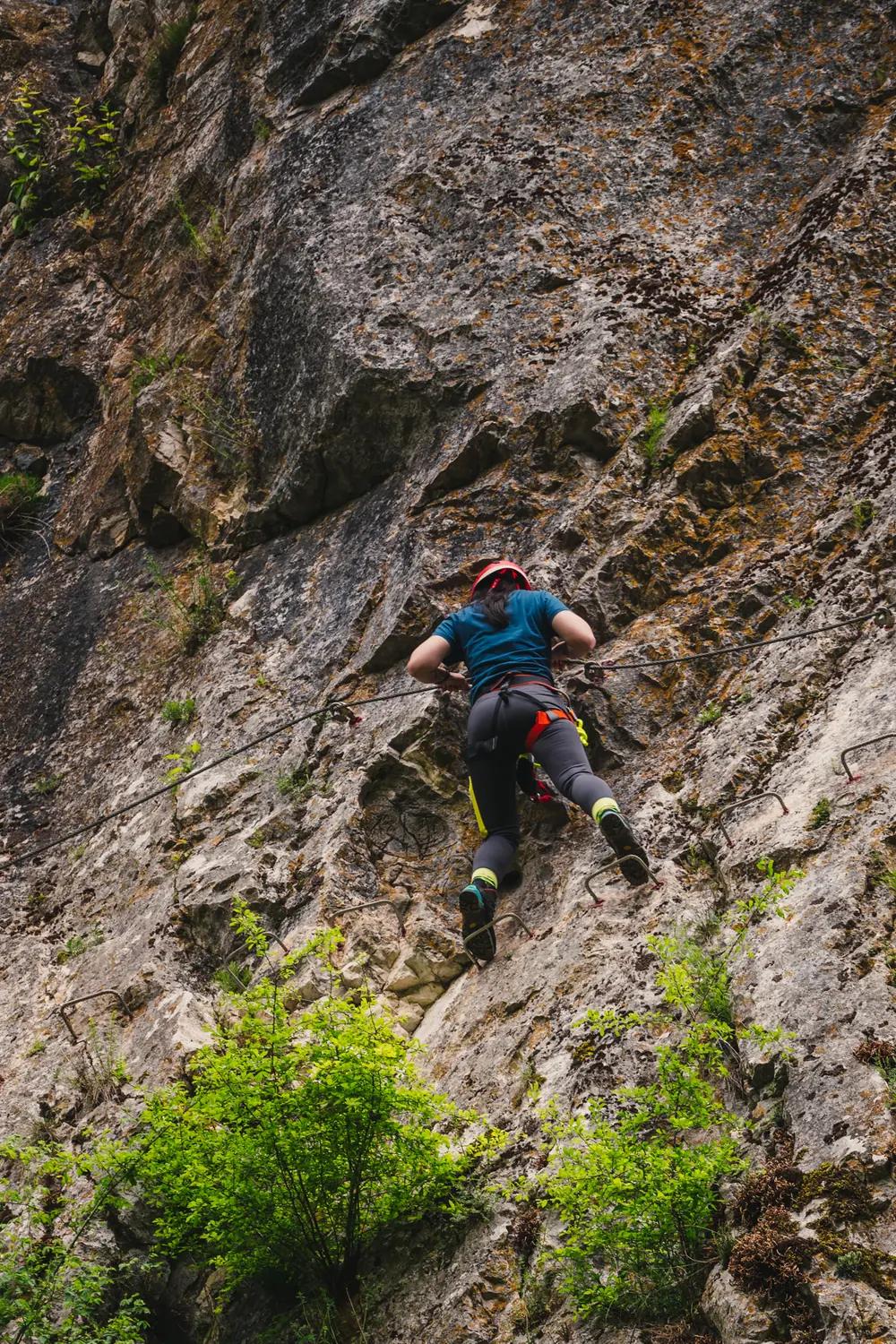 Climbing the limestone wall on the via ferrata route in the Crișul Repede Gorge