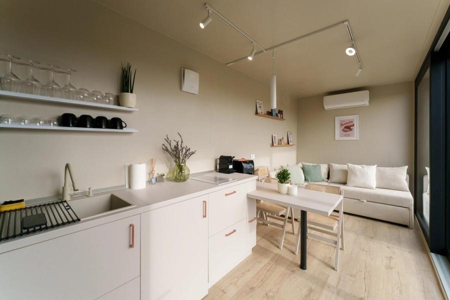 Fully equipped kitchen and living area in a tiny house at Coniferis Retreat