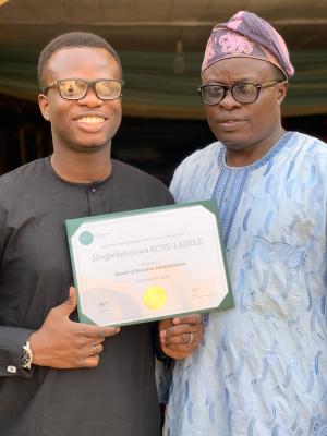 With Gbekeloluwa and his diploma after his MBA graduation