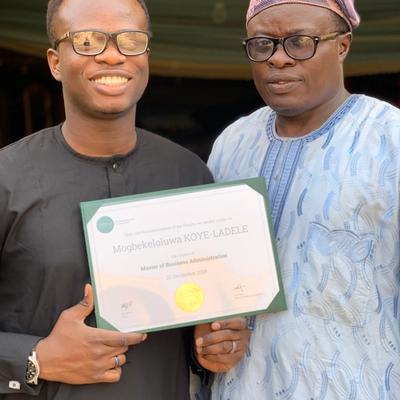 With Gbekeloluwa and his diploma after his MBA graduation