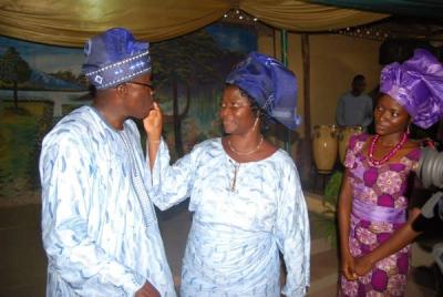 Tasting his birthday cake with Pastor Mrs. Koye-Ladele while Similoluwa looks on