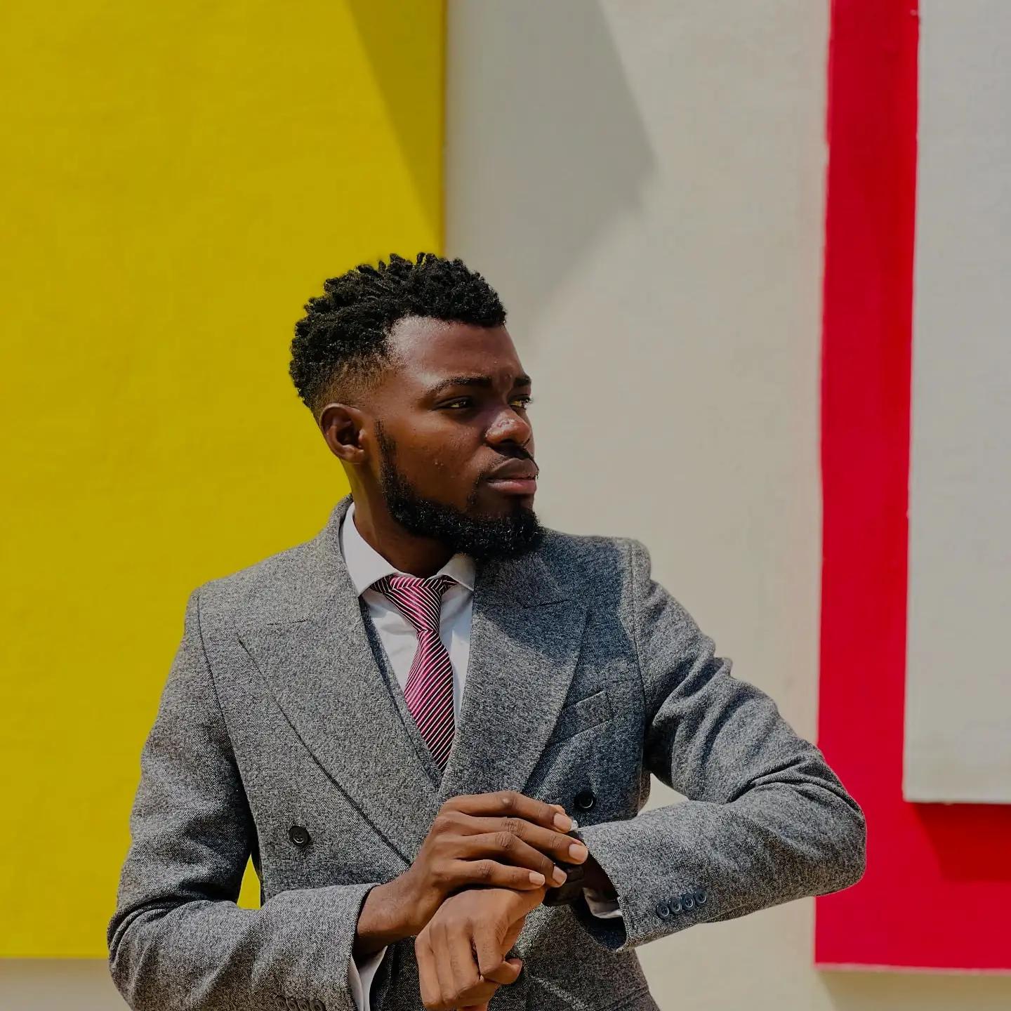 Adetunji Jacob Ogunyemi, Managing Director of Jaylead AgriEstate, in a grey suit against a bright wall