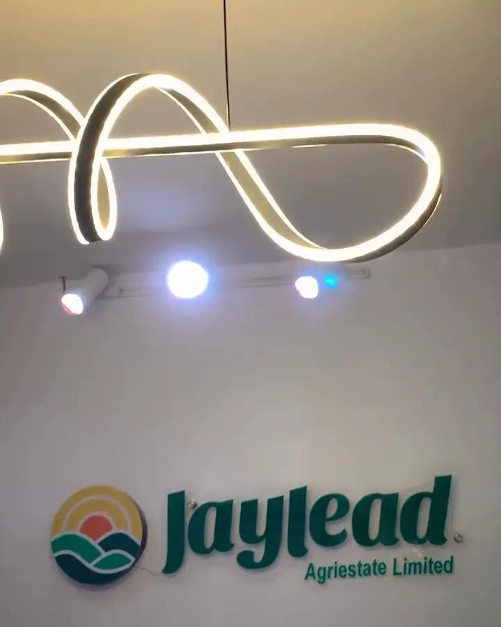 The lit Jaylead AgriEstate logo wall at the office launch