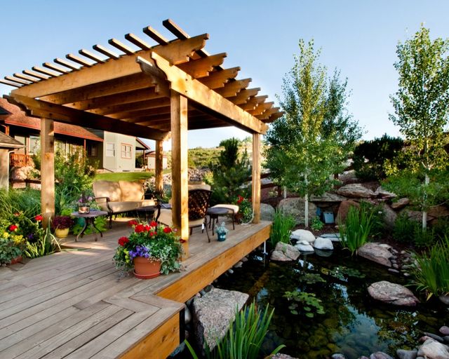 Deck next to pond with pergola