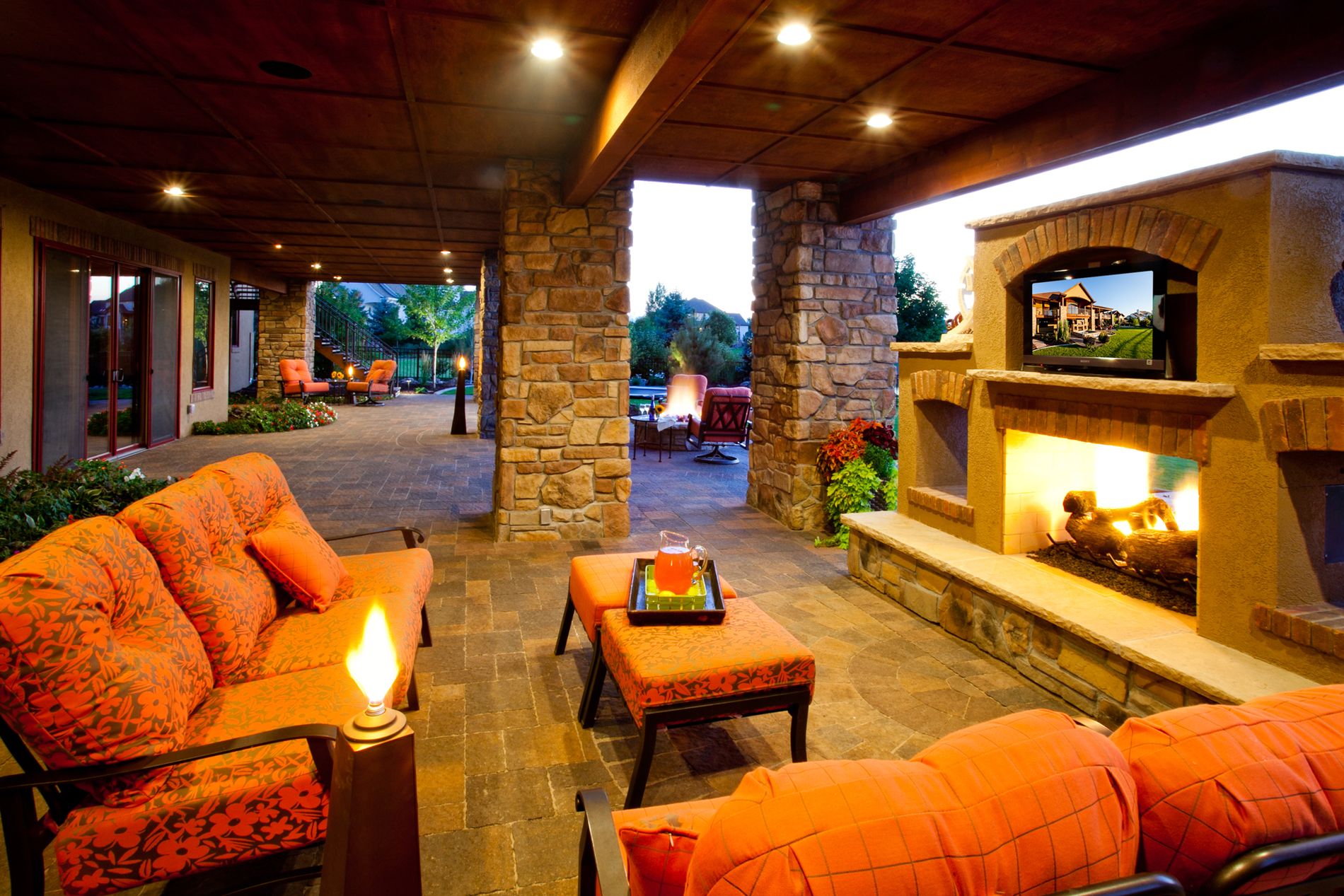 See through fireplace with television and paver patio