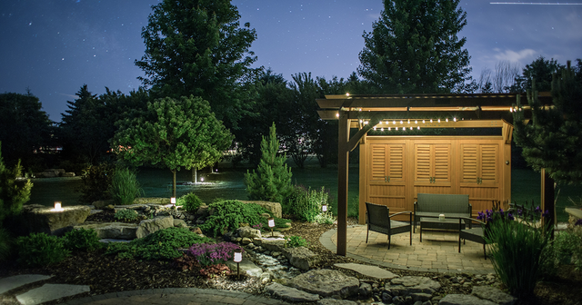 A beautiful landscape at night with lit gazebo